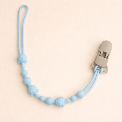 attache tetine en silicone apaisante bleu marine