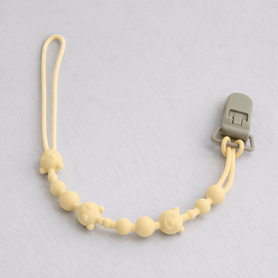 attache tetine en silicone apaisante jaune