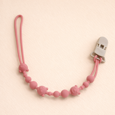 attache tetine en silicone apaisante rose