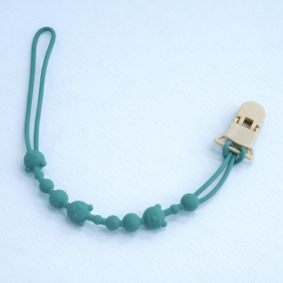 attache tetine en silicone apaisante vert